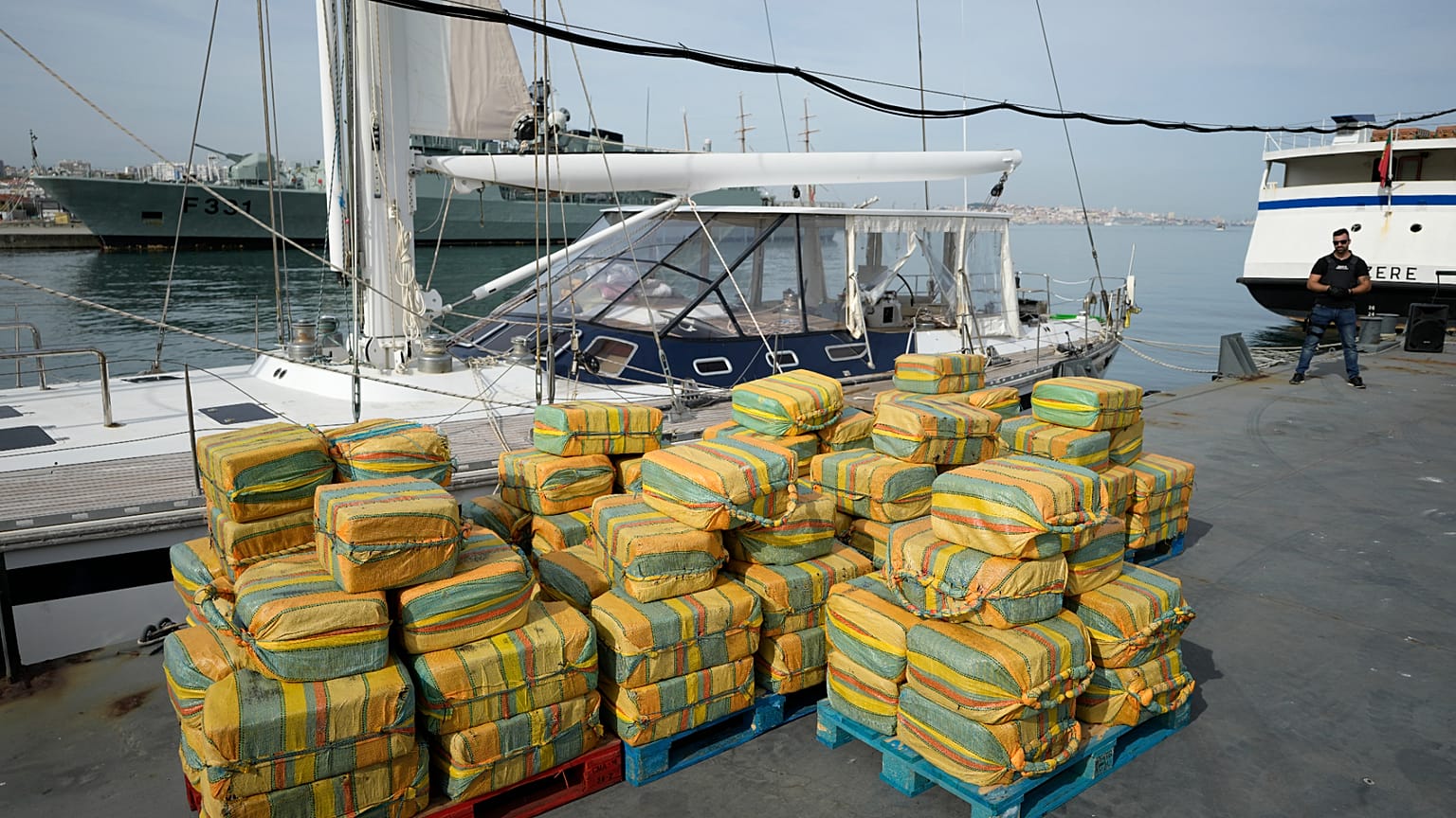  Bales of cocaine weighting some 5,2 tons and a seized yacht are displayed for the media at a Portuguese Navy base in Almada, south of Lisbon, on Oct. 18, 2021. 