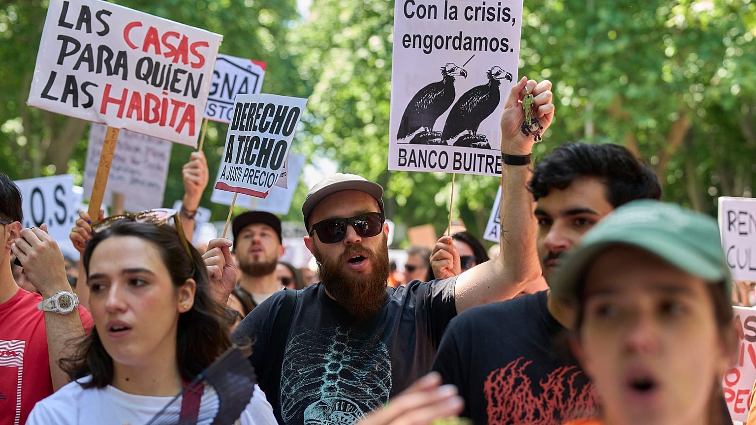 Several people hold a banner reading "Homes for those who live in them" during a protest in Madrid, Spain, on 24 May 2026.