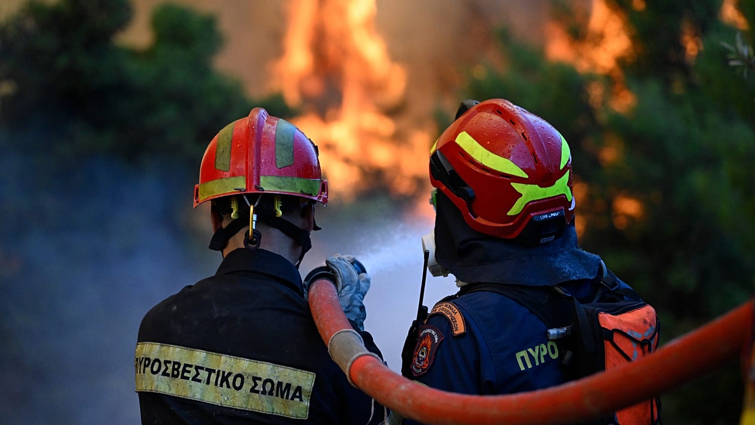 Firefighters operate during a wildfire near Porto Germeno, 2 August, 2026