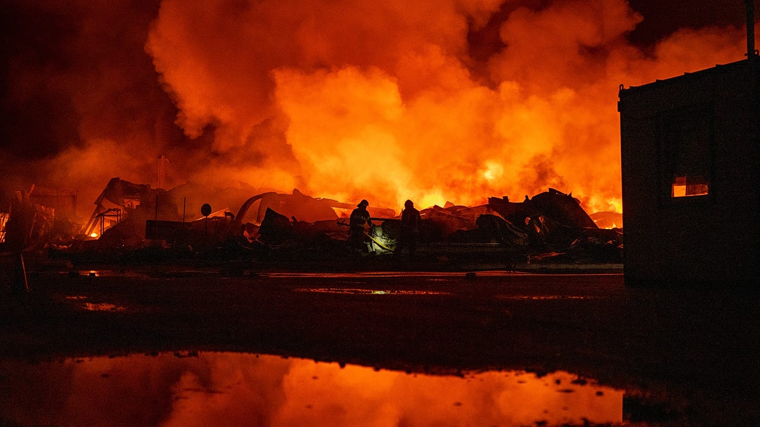 Firefighters put out a fire after Russian missiles hit a warehouse in Kyiv, Ukraine, Wednesday, Aug. 5, 2026. 