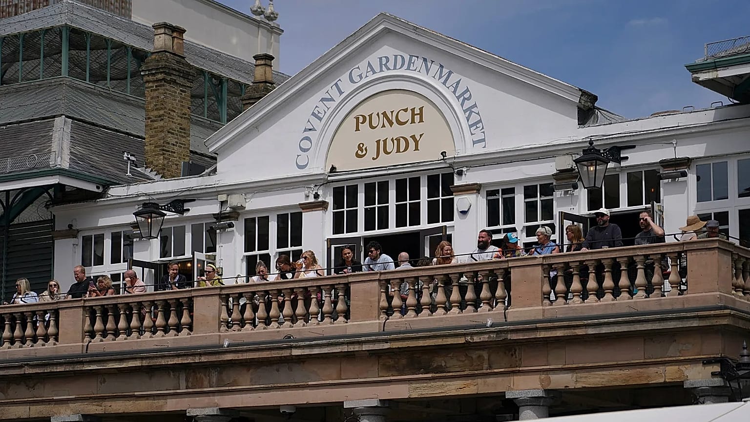 People sit on the terrace of a pub in Covent Garden, in London, Monday, June 29, 2026.