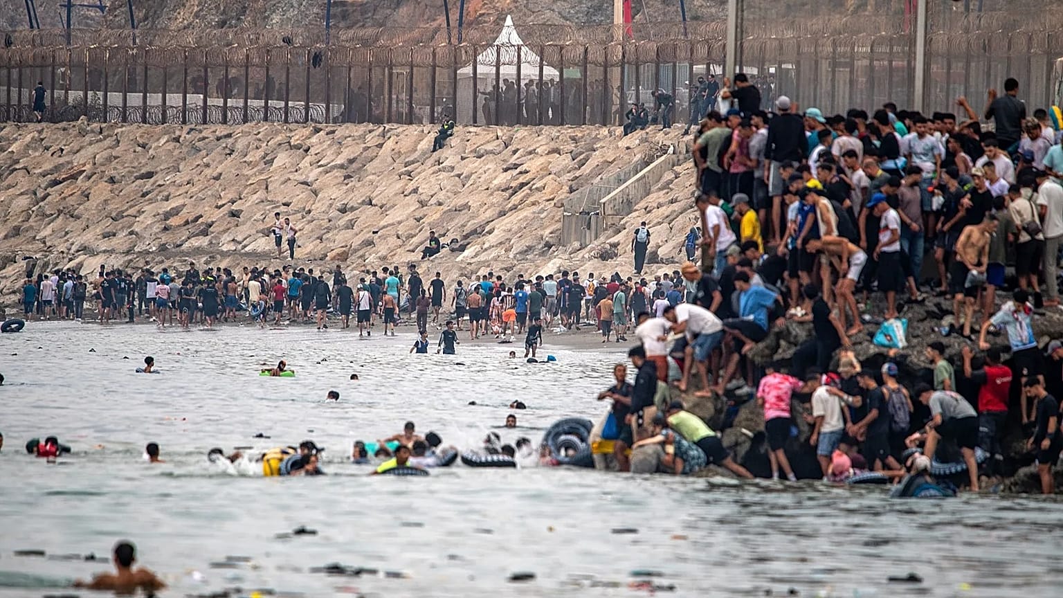 Migrants return to Morocco from the Spanish enclave of Ceuta, Friday, July 31, 2026.