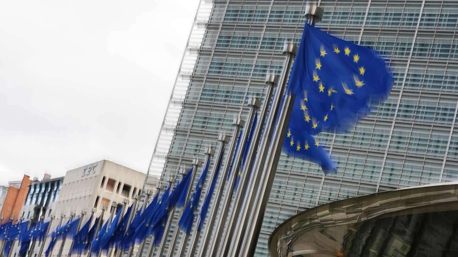 European Union flags flap in the wind outside EU headquarters in Brussels, 12 May, 2026