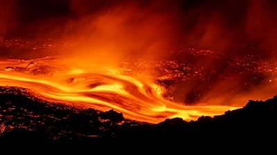 Mount Etna's eruption continues, with lava flows along its slopes seen from Serracozzo on 11 August 2026. (AP Photo/Simone Genovese)