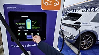 An electric car is charged at a charging point at the Kamener Kreuz before the opening of the largest fast-charging park for e-cars to date operated by the energy company EnB 