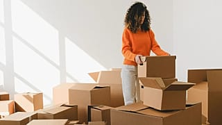 A woman packing boxes to move houses