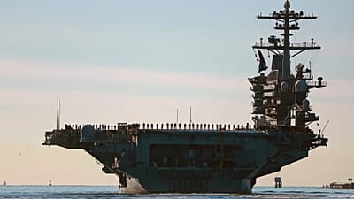 Sailors and Marines line the deck of aircraft carrier USS Abraham Lincoln (CVN-72) as it deploys from San Diego, Jan. 3, 2021.