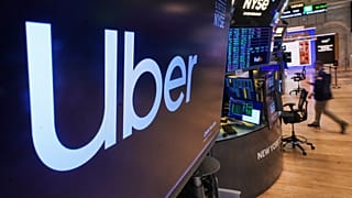 The logo for Uber is displayed above a trading post on the floor of the New York Stock Exchange, Monday, Oct. 20, 2025.